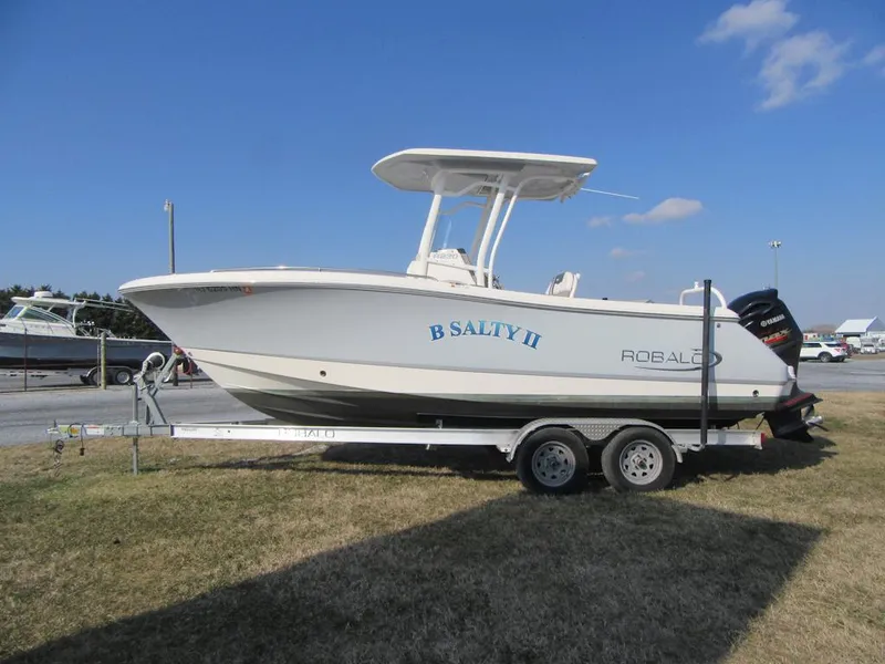 Slide: The Image of 2020 Robalo R230 Center Console boat on trailer, side view, outdoors. - 4