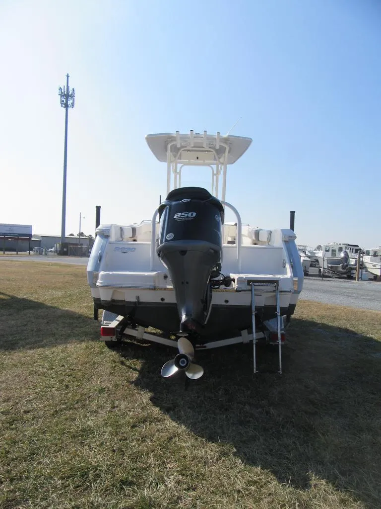 Slide: The Image of 2020 Robalo R230 Center Console boat, rear view with outboard motor, parked on grass. - 5