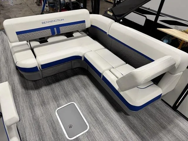 Slide: The Image of 2025 Bennington M Swingback 26 MSB boat interior with white and blue seating arrangement. - 14