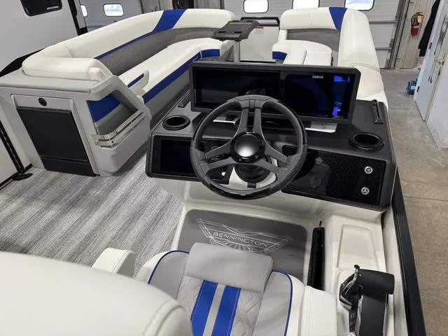 Slide: The Image of 2025 Bennington M Swingback 26 MSB boat interior with modern helm and seating. - 17
