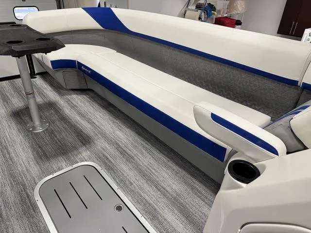 Slide: The Image of 2025 Bennington M Swingback 26 MSB interior with blue and white seating on gray flooring. - 23