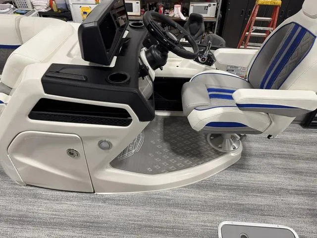 Slide: The Image of 2025 Bennington M Swingback 26 MSB boat interior with modern helm and seating. - 24