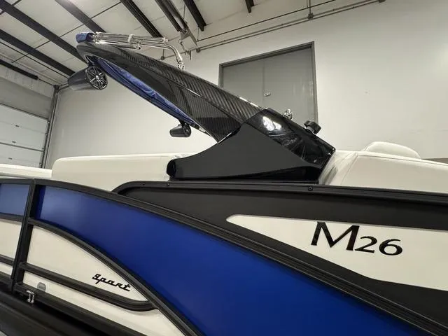 Slide: The Image of 2025 Bennington M Swingback 26 MSB boat layout, top view, showcasing seating and helm positions. - 3