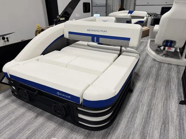Slide: The Image of 2025 Bennington M Swingback 26 MSB pontoon boat with luxurious white and blue seating. - 9