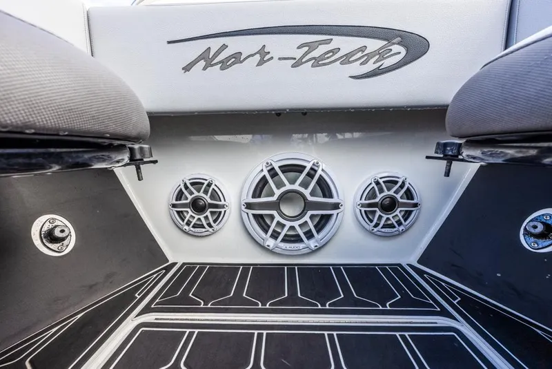 Slide: The Image of 2024 Nor-Tech 392 Super Fish boat interior with speakers and logo detail. - 16