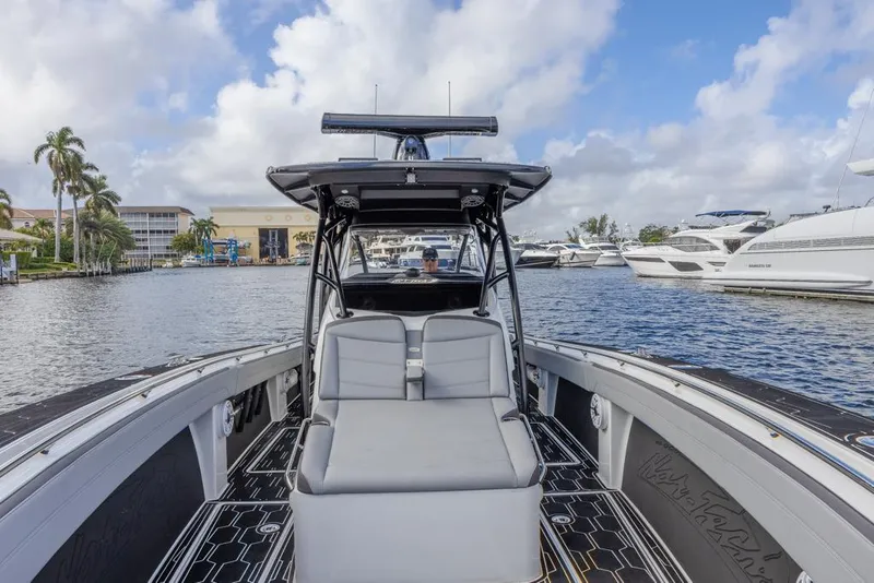 Slide: The Image of 2024 Nor-Tech 392 Super Fish boat docked, featuring sleek design and spacious seating. - 19