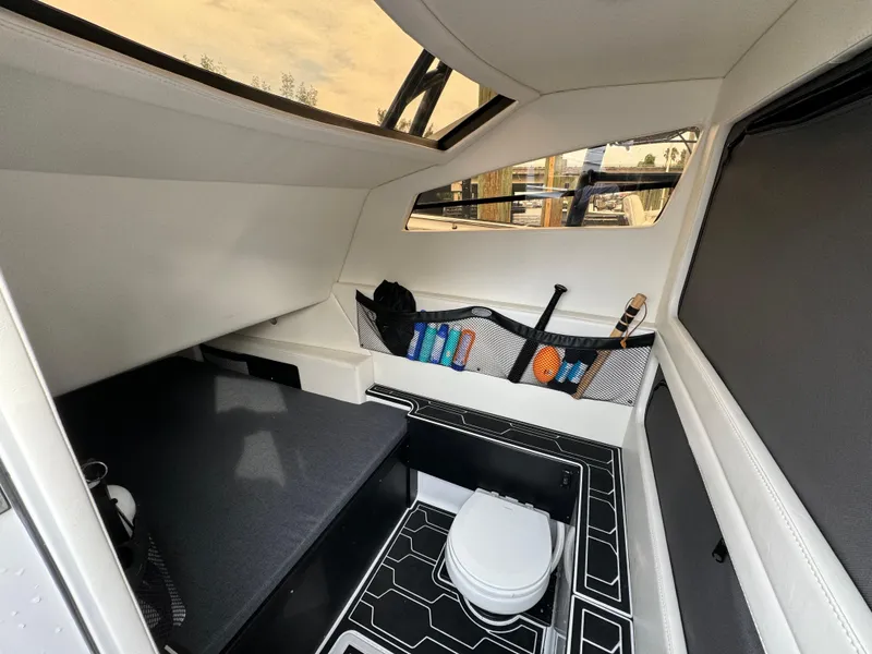 Slide: The Image of Interior cabin of 2024 Nor-Tech 392 Super Fish boat, featuring seating and storage. - 23