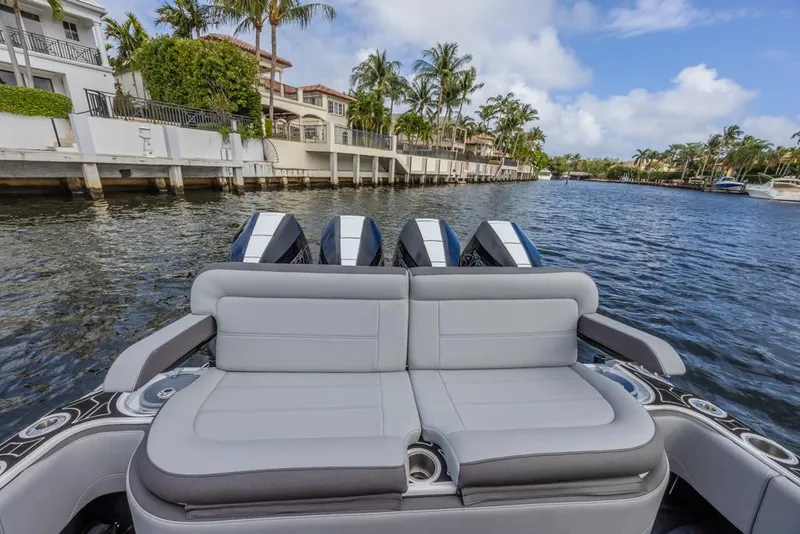 Slide: The Image of 2024 Nor-Tech 392 Super Fish boat with luxurious seating on a scenic waterway. - 25