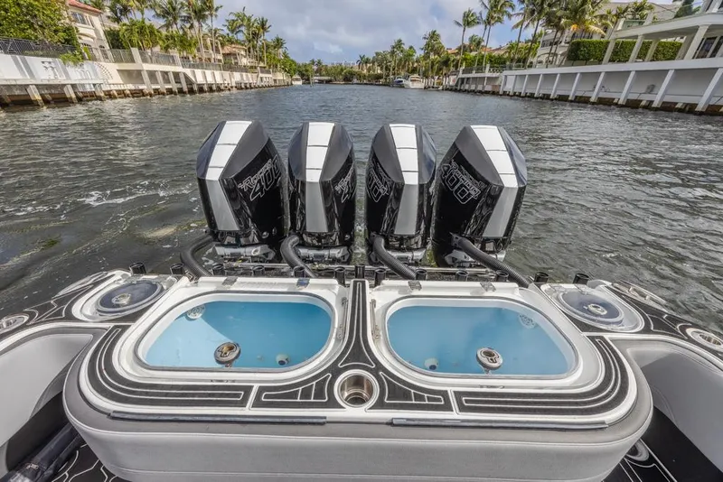 Slide: The Image of 2024 Nor-Tech 392 Super Fish boat with four powerful engines on a scenic waterway. - 26