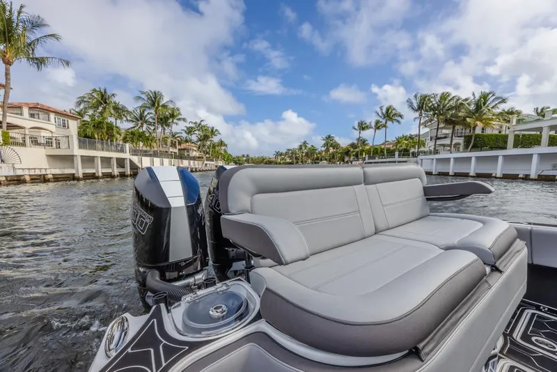 Slide: The Image of 2024 Nor-Tech 392 Super Fish boat with luxurious seating on a scenic waterway. - 29