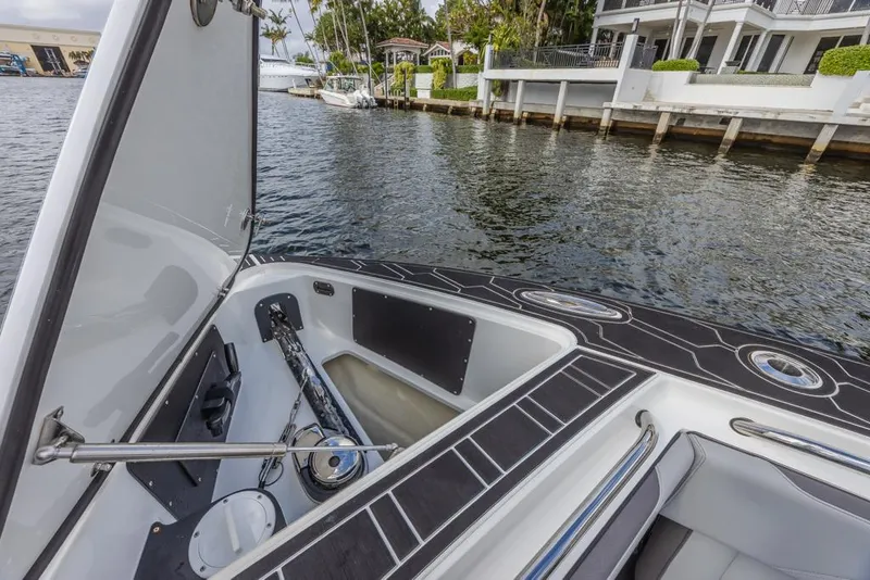 Slide: The Image of 2024 Nor-Tech 392 Super Fish boat interior with open storage compartment by waterfront. - 34
