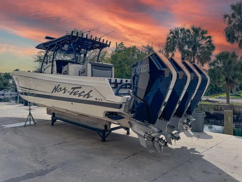 Slide: The Image of 2024 Nor-Tech 392 Super Fish boat with quad engines at sunset. - 6