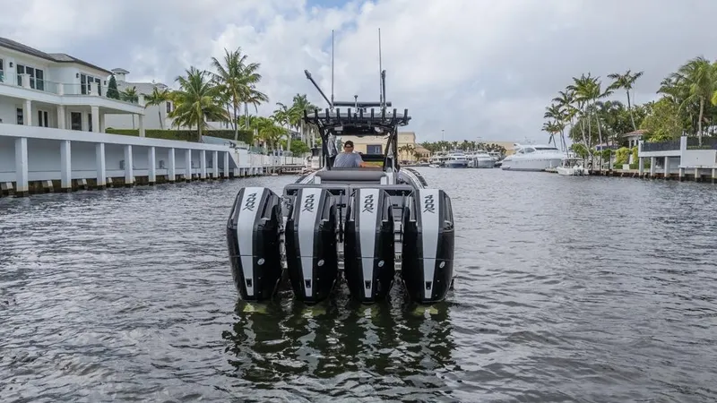 Slide: The Image of 2024 Nor-Tech 392 Super Fish boat with four powerful engines on a scenic waterway. - 7