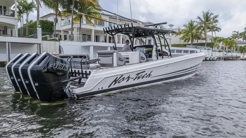 Slide: The Image of 2024 Nor-Tech 392 Super Fish boat with quad engines on a scenic waterway. - 9