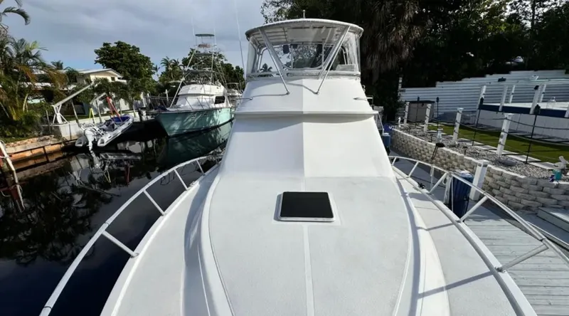 Slide: The Image of 1987 Blackfin Convertible yacht docked in a marina, showcasing sleek design and spacious deck. - 11