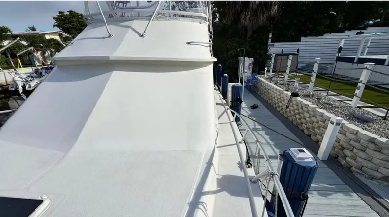 Slide: The Image of 1987 Blackfin Convertible boat docked, showing deck and railing details. - 12