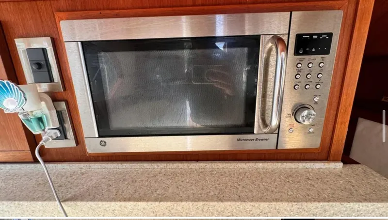 Slide: The Image of Microwave oven in 1987 Blackfin Convertible boat kitchen, with wooden cabinetry and countertop. - 26