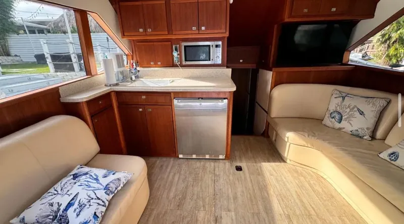 Slide: The Image of Interior of a 1987 Blackfin Convertible yacht with modern kitchen and seating area. - 32