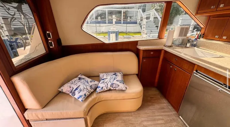 Slide: The Image of Interior of 1987 Blackfin Convertible yacht with beige seating and wooden cabinetry. - 33