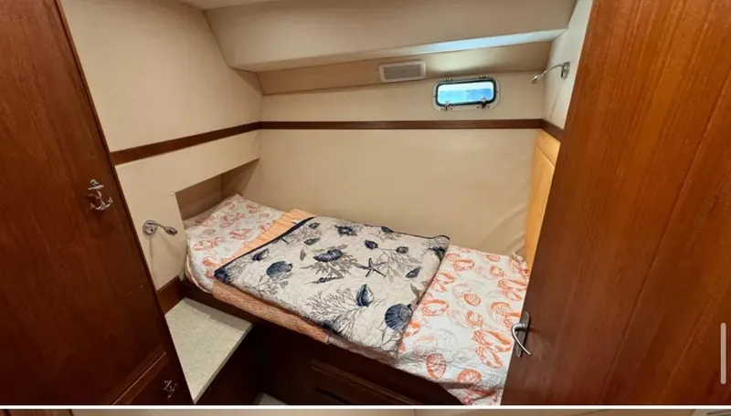 Slide: The Image of 1987 Blackfin Convertible cabin interior with cozy bed and wooden furnishings. - 40