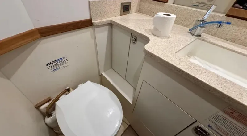 Slide: The Image of 1987 Blackfin Convertible yacht bathroom with toilet, sink, and countertop. - 44
