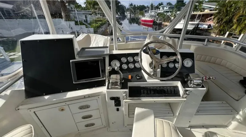 Slide: The Image of 1987 Blackfin Convertible boat cockpit with steering wheel, gauges, and navigation equipment. - 48
