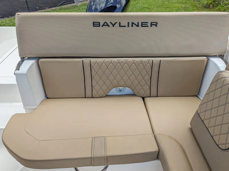 Slide: The Image of 2024 Bayliner DX2000 boat with beige cushioned seating and quilted design. - 12