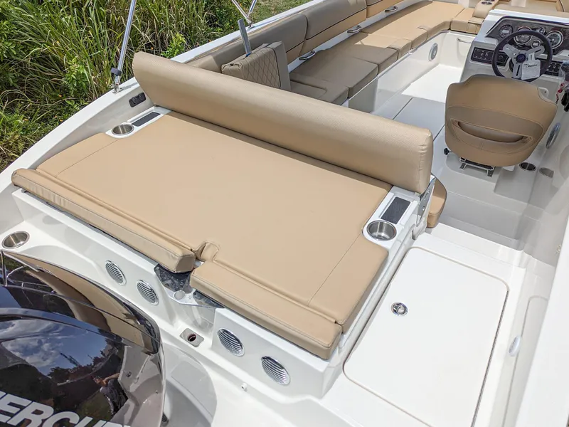 Slide: The Image of 2024 Bayliner DX2000 boat interior with beige seating and modern dashboard. - 6