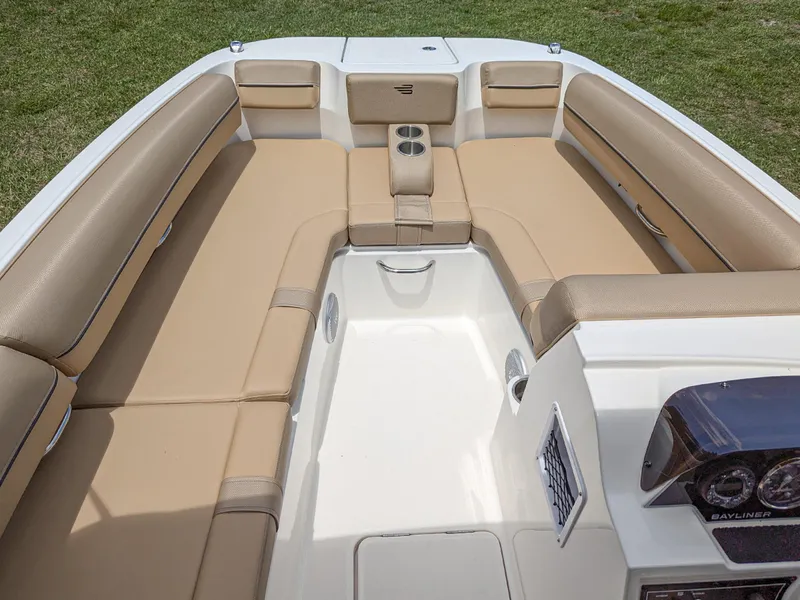 Slide: The Image of 2024 Bayliner DX2000 boat interior with tan seating and cup holders. - 7