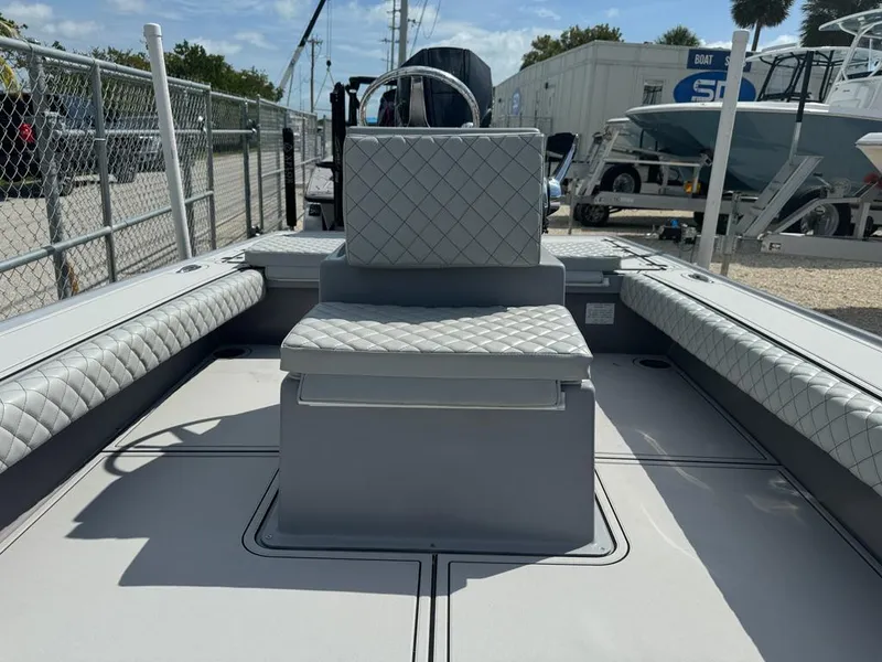 Slide: The Image of Custom Key Hopper 20 boat interior with quilted seating, 2023 model, docked at marina. - 10