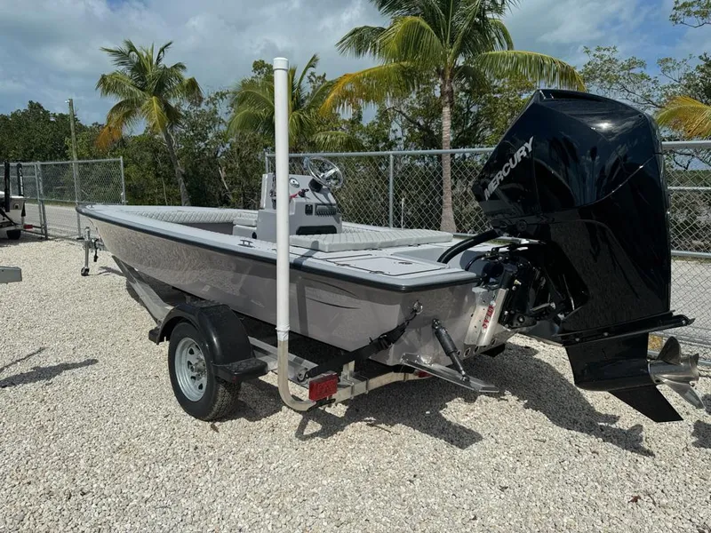 Slide: The Image of Custom Key Hopper 20 boat, 2023 model, on trailer with Mercury outboard motor, palm trees in background. - 5