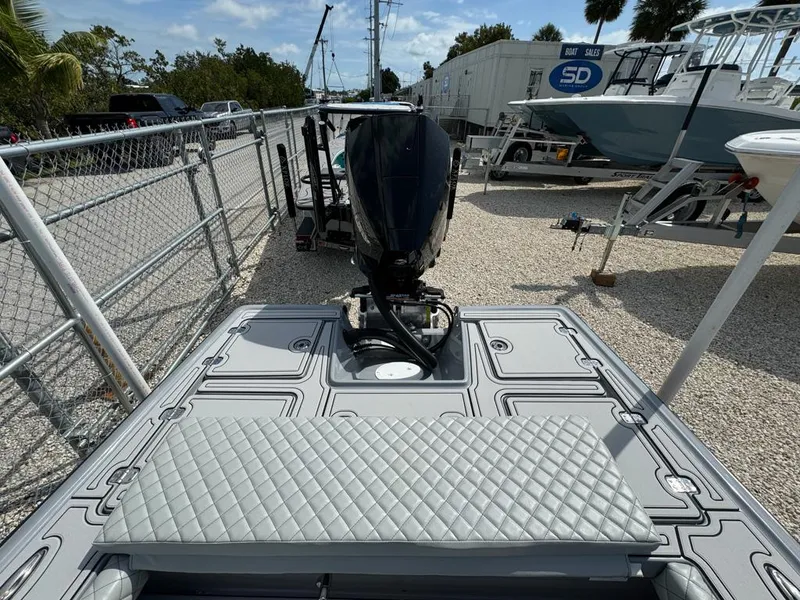 Slide: The Image of Custom Key Hopper 20 boat, 2023 model, with outboard motor in a marina setting. - 6