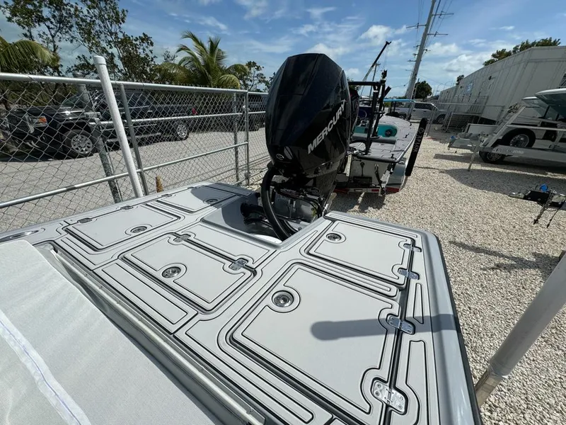 Slide: The Image of Custom Key Hopper 20 boat with Mercury engine, parked on gravel near fence, 2023 model. - 7