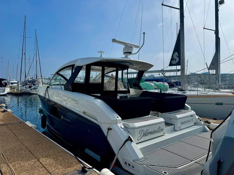 Slide: The Image of 2020 Cruisers Yachts 39 Express Coupe docked at marina under clear blue sky. - 22