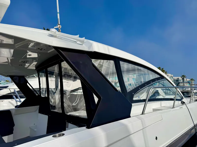 Slide: The Image of 2020 Cruisers Yachts 39 Express Coupe, sleek design, docked under clear blue sky. - 23