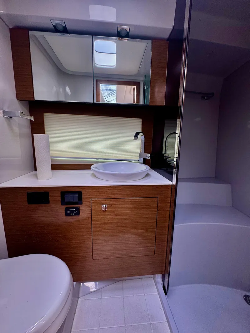 Slide: The Image of 2020 Cruisers Yachts 39 Express Coupe bathroom with modern fixtures and wood accents. - 25
