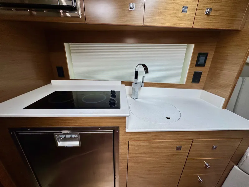 Slide: The Image of Modern kitchen in 2020 Cruisers Yachts 39 Express Coupe with stovetop and sink. - 26