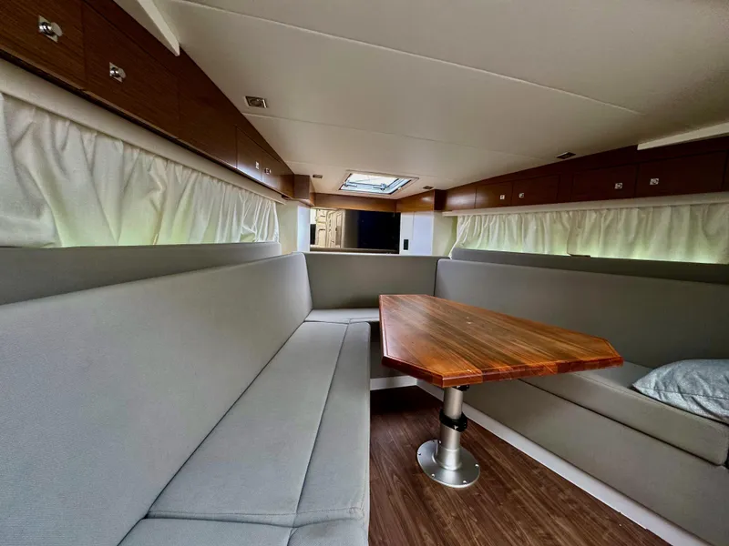 Slide: The Image of Interior of 2020 Cruisers Yachts 39 Express Coupe with modern seating and wooden table. - 27