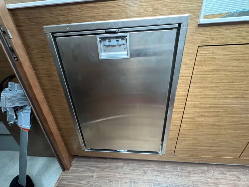Slide: The Image of Stainless steel refrigerator in 2020 Cruisers Yachts 39 Express Coupe interior. - 28
