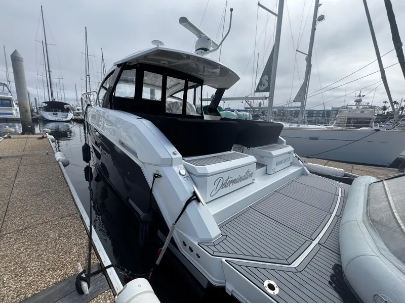 Slide: The Image of 2020 Cruisers Yachts 39 Express Coupe docked at marina, rear view. - 33