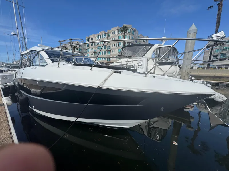 Slide: The Image of 2020 Cruisers Yachts 39 Express Coupe docked in marina, clear sky background. - 34