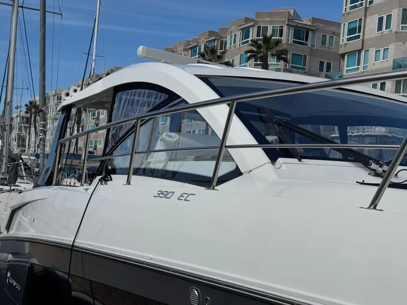 Slide: The Image of 2020 Cruisers Yachts 39 Express Coupe docked near modern buildings. - 35