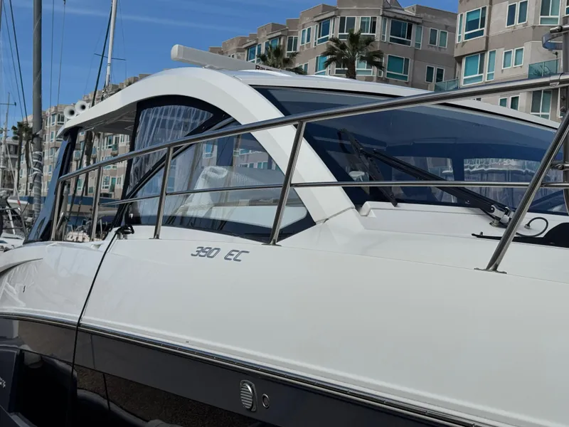 Slide: The Image of 2020 Cruisers Yachts 39 Express Coupe docked near modern apartments. - 36