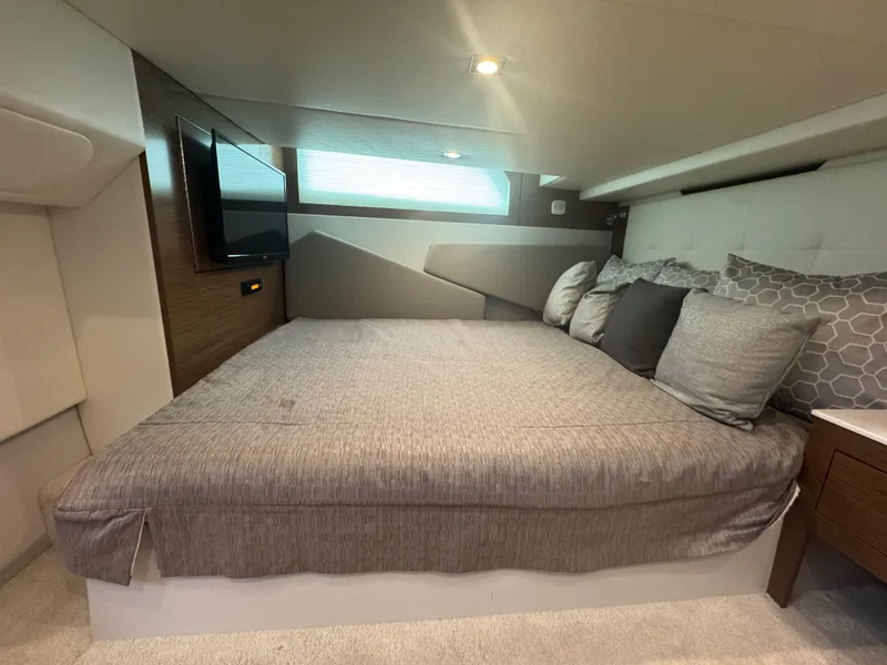 Slide: The Image of Luxurious cabin interior of 2020 Cruisers Yachts 39 Express Coupe with cozy bedding. - 38
