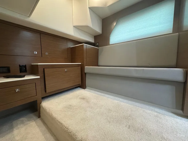 Slide: The Image of Interior of 2020 Cruisers Yachts 39 Express Coupe with modern wood cabinetry and seating. - 42