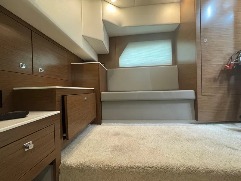 Slide: The Image of Interior of 2020 Cruisers Yachts 39 Express Coupe with modern wood cabinetry and seating. - 43