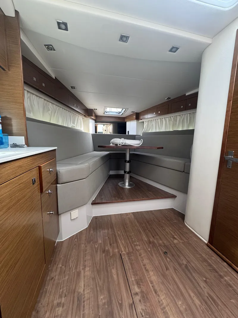 Slide: The Image of Interior of 2020 Cruisers Yachts 39 Express Coupe with modern seating and wooden finishes. - 44