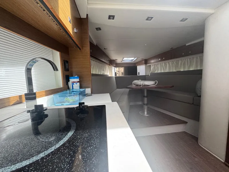 Slide: The Image of Interior of 2020 Cruisers Yachts 39 Express Coupe, featuring modern kitchen and seating area. - 45