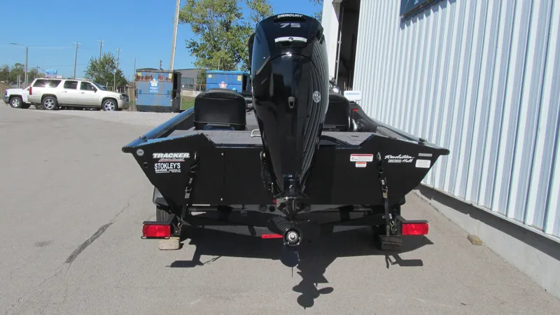 Slide: The Image of 2024 Tracker Pro Team 175 TF boat with outboard motor, parked on a trailer. - 4