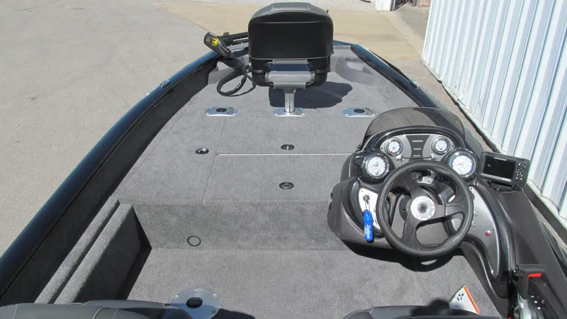 Slide: The Image of 2024 Tracker Pro Team 175 TF boat interior with steering console and seating. - 5